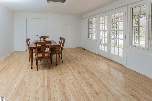 3080 N Lake Leelanau Dr, Lake Leelanau, MI 49653 - dining room with hardwood / wood-style floors, ornamental molding, and baseboards