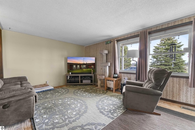 3610 S Call Rd, Lake City, MI 49651 - living area featuring a textured ceiling and wallpapered walls
