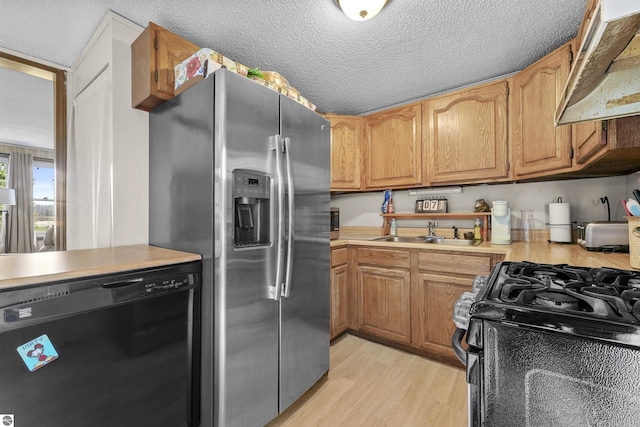 3610 S Call Rd, Lake City, MI 49651 - kitchen featuring black appliances, a sink, under cabinet range hood, light countertops, and light wood-type flooring