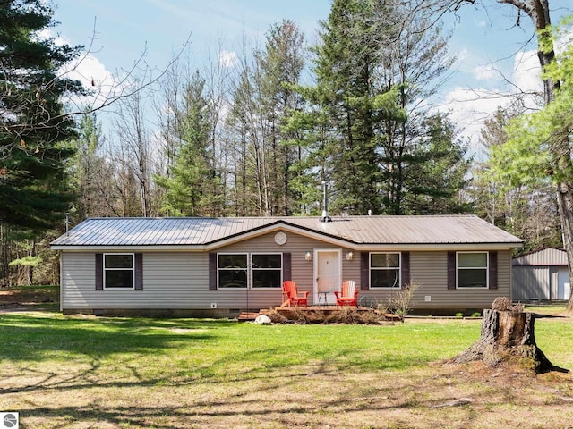 12036 SW Spring Creek Rd, Fife Lake, MI 49633 - view of front facade featuring crawl space, metal roof, and a front yard
