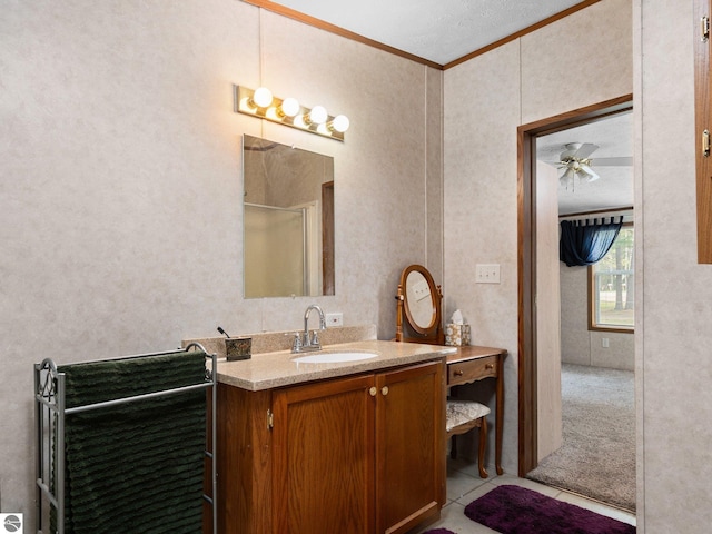 12036 SW Spring Creek Rd, Fife Lake, MI 49633 - full bathroom with ornamental molding, vanity, a ceiling fan, tile patterned flooring, and a shower