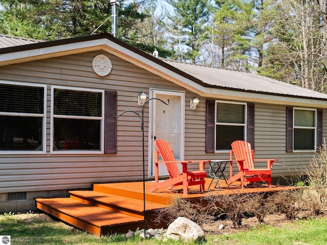 12036 SW Spring Creek Rd, Fife Lake, MI 49633 - view of front of house with metal roof and crawl space