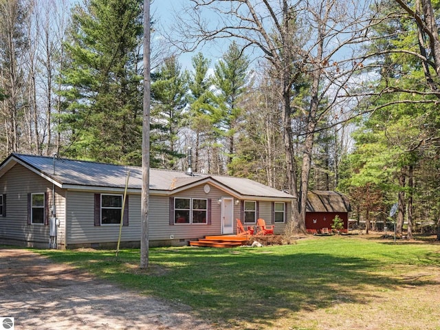12036 SW Spring Creek Rd, Fife Lake, MI 49633 - ranch-style house featuring crawl space, metal roof, a front lawn, and dirt driveway