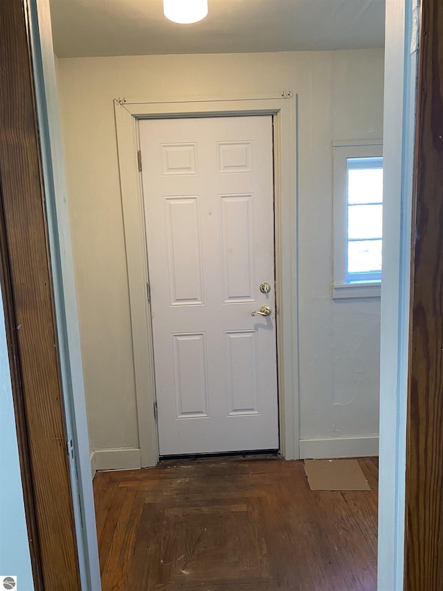 doorway to outside featuring baseboards