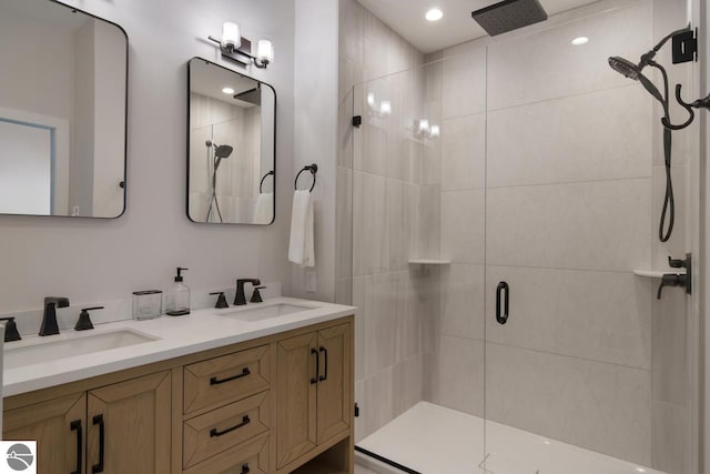 127 River St, Elk Rapids, MI 49629 - full bath with a stall shower, double vanity, and recessed lighting