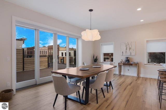 127 River St, Elk Rapids, MI 49629 - dining space featuring a chandelier, light wood-style flooring, recessed lighting, and baseboards