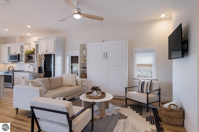 127 River St, Elk Rapids, MI 49629 - living area with light wood-style flooring, a ceiling fan, recessed lighting, and baseboards