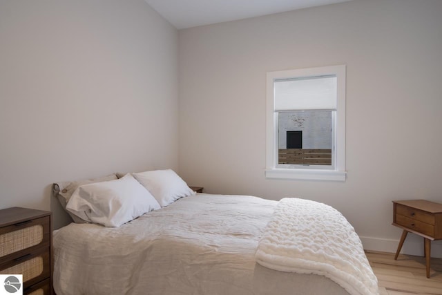 127 River St, Elk Rapids, MI 49629 - bedroom featuring wood finished floors and baseboards