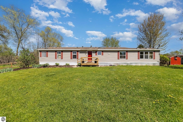 10946 N Rich Rd, Alma, MI 48801 - manufactured / mobile home featuring a shed and an outbuilding