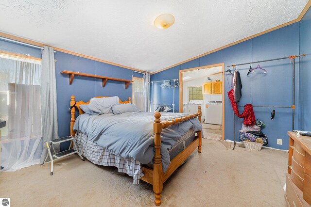10946 N Rich Rd, Alma, MI 48801 - bedroom featuring vaulted ceiling, washing machine and dryer, carpet floors, a textured ceiling, and ornamental molding
