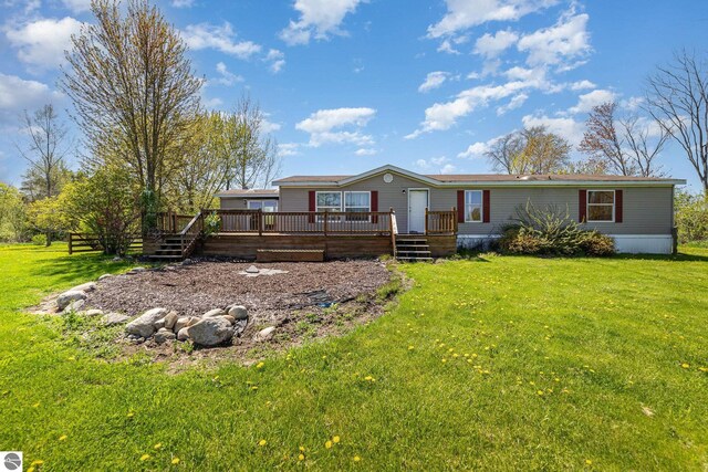 10946 N Rich Rd, Alma, MI 48801 - view of front of home featuring a deck and a front lawn