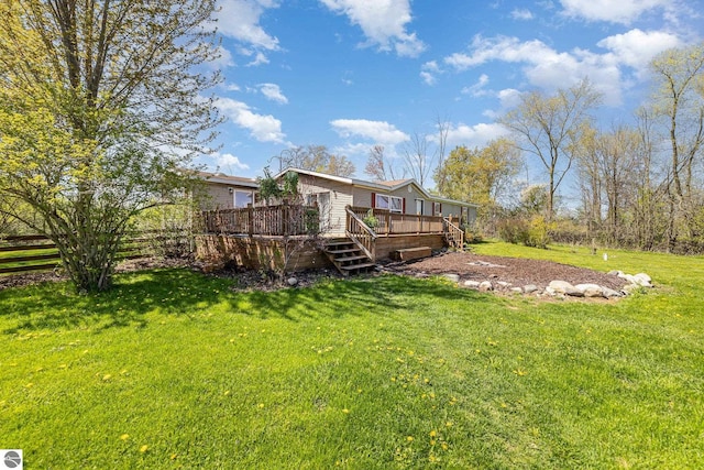 10946 N Rich Rd, Alma, MI 48801 - back of property featuring a deck and a yard