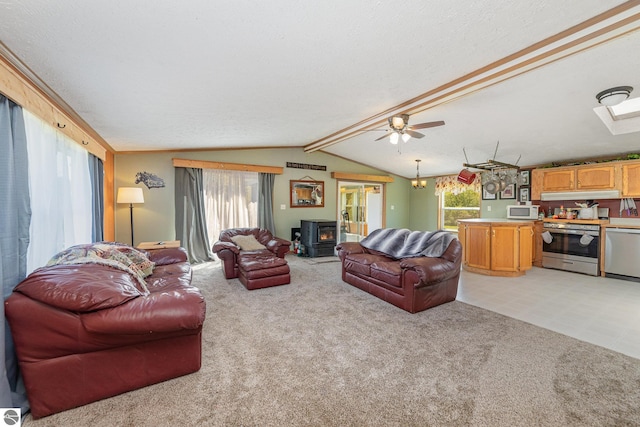 10946 N Rich Rd, Alma, MI 48801 - living room with a wood stove, light carpet, a textured ceiling, a skylight, and a ceiling fan