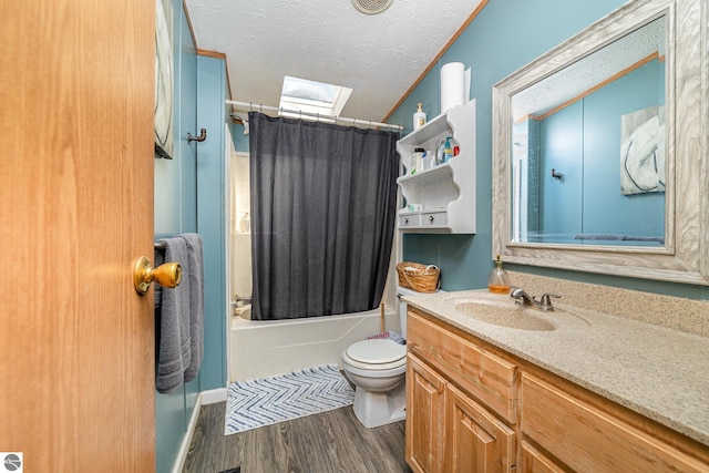 10946 N Rich Rd, Alma, MI 48801 - full bath with a skylight, wood finished floors, toilet, vanity, and shower / tub combo