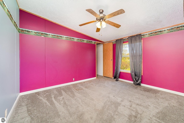 10946 N Rich Rd, Alma, MI 48801 - carpeted spare room featuring vaulted ceiling, a ceiling fan, baseboards, and a textured ceiling