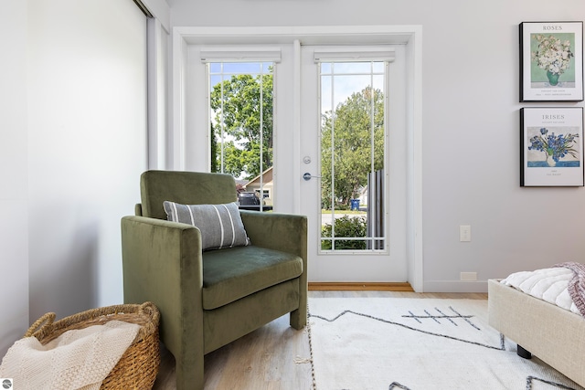 sitting room with wood finished floors and baseboards