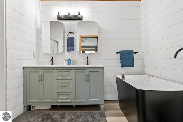11420 Muskie Way, Ellsworth, MI 49729 - full bath featuring wood finished floors, double vanity, and wooden walls
