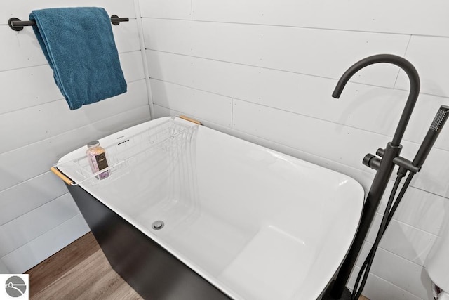 11420 Muskie Way, Ellsworth, MI 49729 - full bath with a freestanding tub and wood finished floors