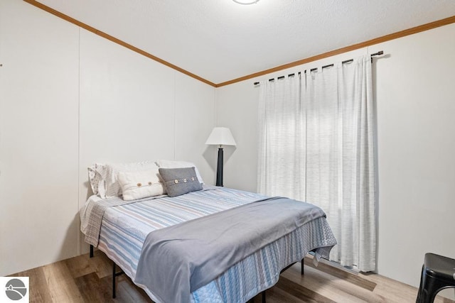 11420 Muskie Way, Ellsworth, MI 49729 - bedroom with ornamental molding, wood finished floors, and vaulted ceiling