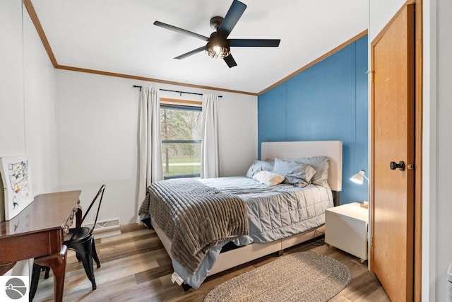 11420 Muskie Way, Ellsworth, MI 49729 - bedroom with crown molding, wood finished floors, and a ceiling fan