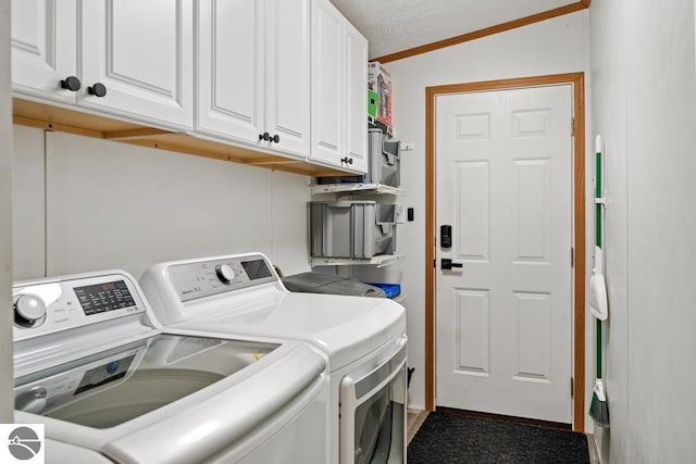 11420 Muskie Way, Ellsworth, MI 49729 - laundry area featuring washing machine and clothes dryer, cabinet space, and crown molding