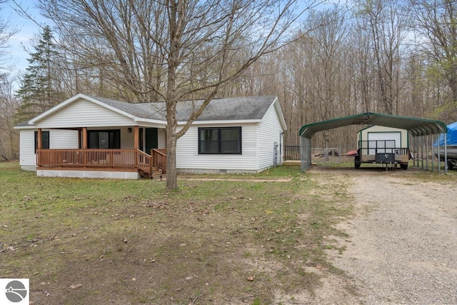 11420 Muskie Way, Ellsworth, MI 49729 - view of front of property featuring covered porch, driveway, a carport, crawl space, and a shingled roof