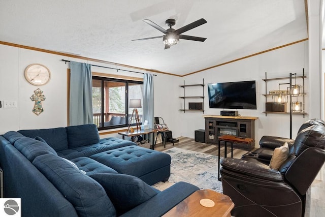 11420 Muskie Way, Ellsworth, MI 49729 - living room with vaulted ceiling, wood finished floors, a ceiling fan, and ornamental molding