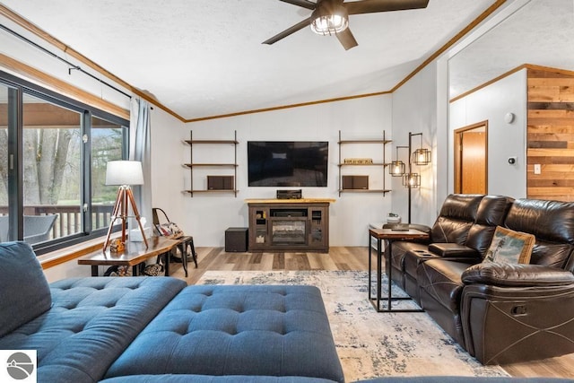 11420 Muskie Way, Ellsworth, MI 49729 - living room with vaulted ceiling, wood finished floors, a ceiling fan, and ornamental molding