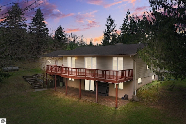 11531 S Tower Rd, Maple City, MI 49664 - back of property featuring a wooden deck, a lawn, and stairs