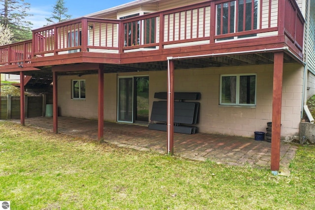 11531 S Tower Rd, Maple City, MI 49664 - back of house with a patio, a yard, a wooden deck, and concrete block siding