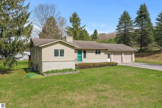 11531 S Tower Rd, Maple City, MI 49664 - single story home with a garage, a chimney, concrete driveway, brick siding, and a front lawn