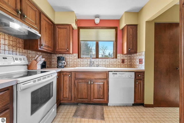 11531 S Tower Rd, Maple City, MI 49664 - kitchen with white appliances, under cabinet range hood, a sink, light floors, and light countertops
