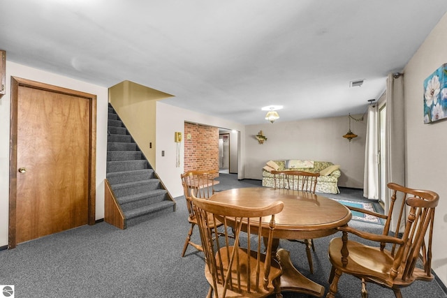 11531 S Tower Rd, Maple City, MI 49664 - dining area featuring carpet flooring and stairway
