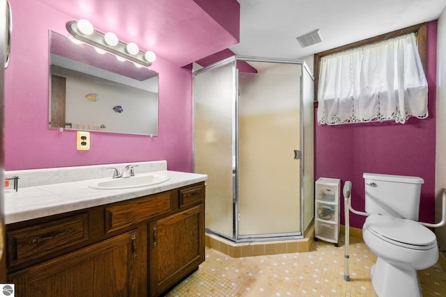 11531 S Tower Rd, Maple City, MI 49664 - full bath featuring vanity, toilet, a stall shower, and tile patterned flooring