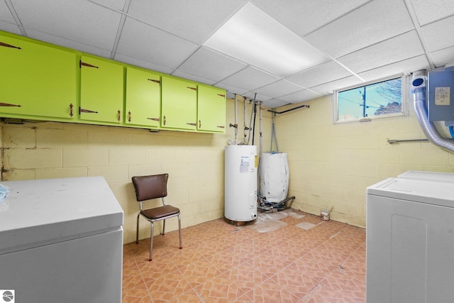 11531 S Tower Rd, Maple City, MI 49664 - laundry room with cabinet space, water heater, washer and clothes dryer, concrete block wall, and light floors