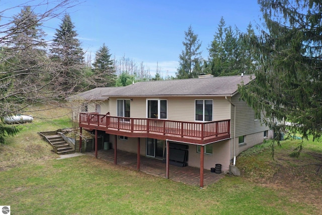 11531 S Tower Rd, Maple City, MI 49664 - rear view of property featuring a deck, a lawn, and stairway