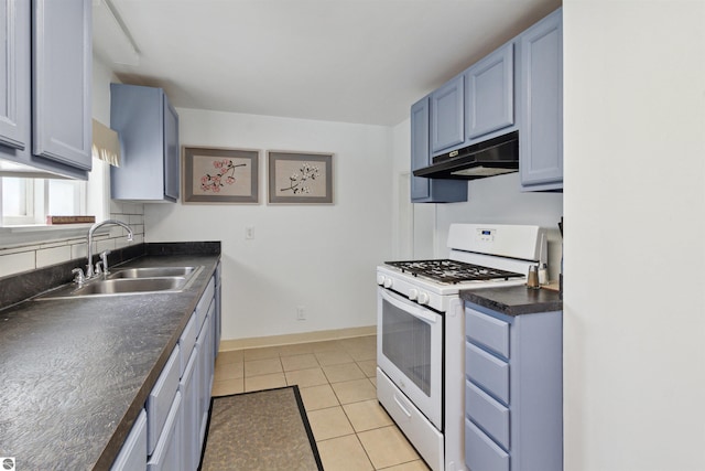 1040 Eastward St, Alma, MI 48801 - kitchen featuring under cabinet range hood, white gas range oven, a sink, dark countertops, and light tile patterned flooring