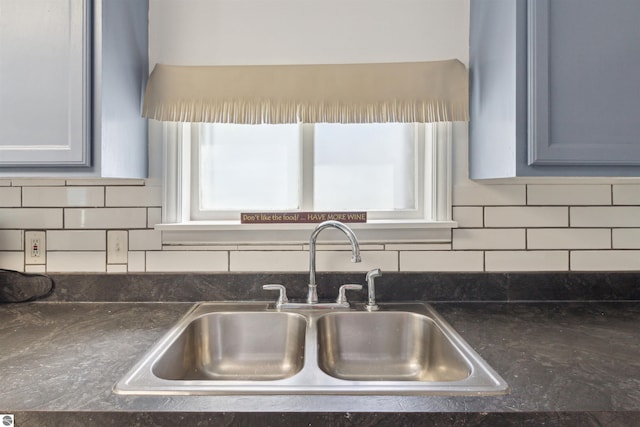 1040 Eastward St, Alma, MI 48801 - kitchen view of a sink, dark countertops, and decorative backsplash