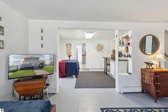 1040 Eastward St, Alma, MI 48801 - living area featuring a baseboard radiator and finished concrete floors