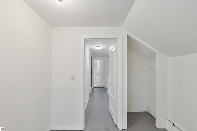 1040 Eastward St, Alma, MI 48801 - hallway with a baseboard radiator, lofted ceiling, and baseboards