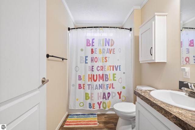 714 SE Saunders Rd, Kalkaska, MI 49646 - full bath with ornamental molding, vanity, toilet, wood finished floors, and shower / bath combo with shower curtain