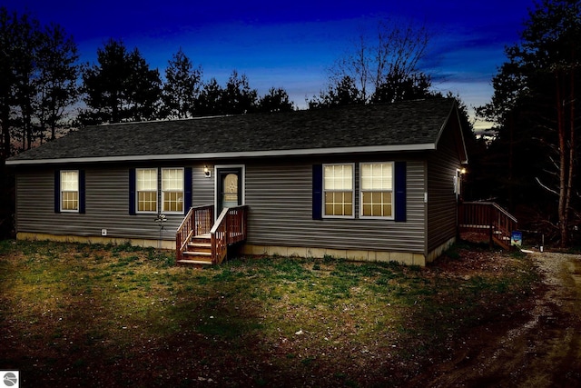 714 SE Saunders Rd, Kalkaska, MI 49646 - view of front of property featuring roof with shingles and a front yard