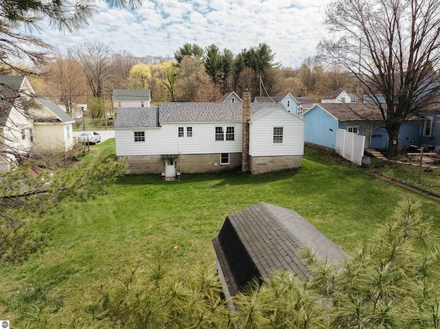 back of house with a lawn