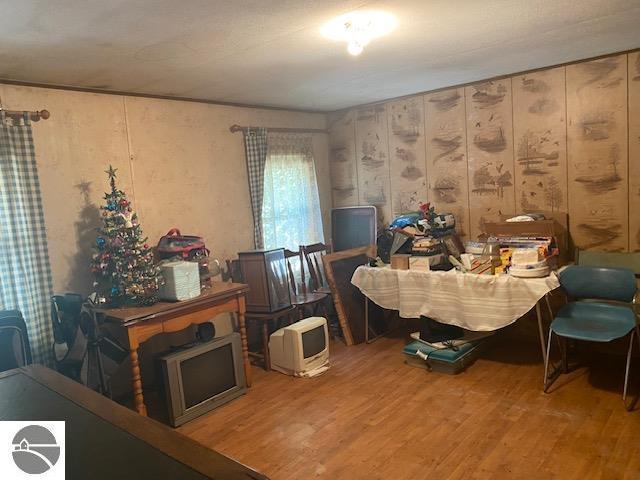 8067 Cherry Ave, Rapid City, MI 49676 - dining area featuring wood finished floors