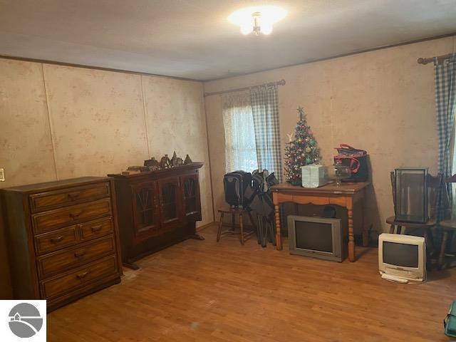 8067 Cherry Ave, Rapid City, MI 49676 - sitting room with wood finished floors