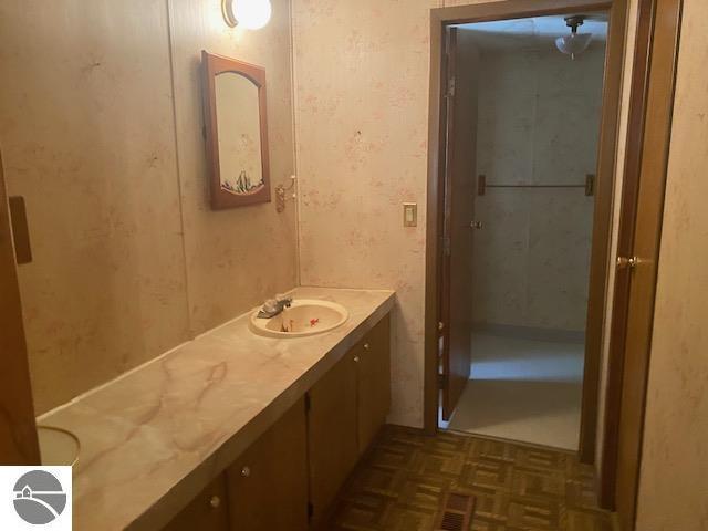 8067 Cherry Ave, Rapid City, MI 49676 - bathroom featuring vanity