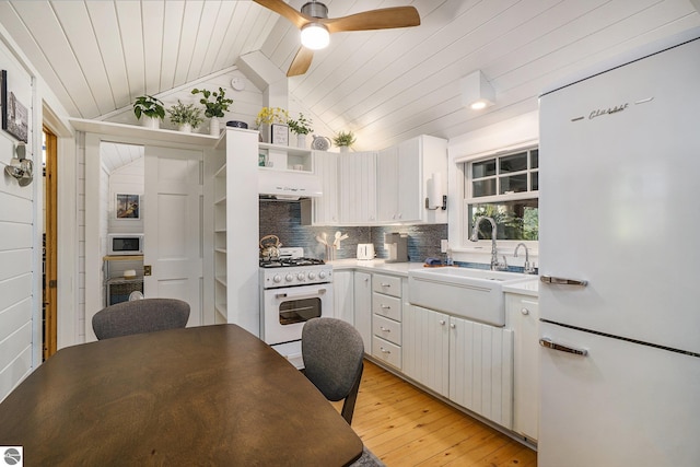 421 S Shabwasung St, Northport, MI 49670 - kitchen featuring white appliances, wood ceiling, a sink, light wood-type flooring, and a ceiling fan