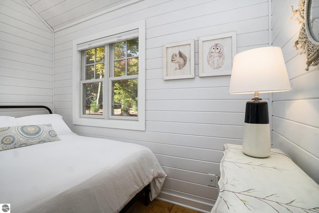 421 S Shabwasung St, Northport, MI 49670 - bedroom with wood walls, wood finished floors, and lofted ceiling