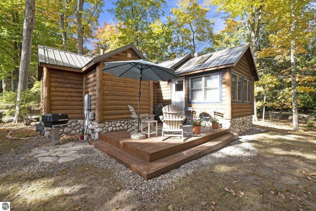 421 S Shabwasung St, Northport, MI 49670 - deck featuring a grill and an outbuilding