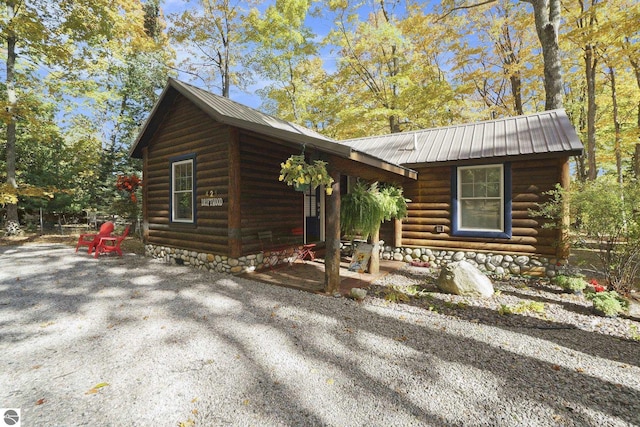 421 S Shabwasung St, Northport, MI 49670 - log-style house featuring metal roof